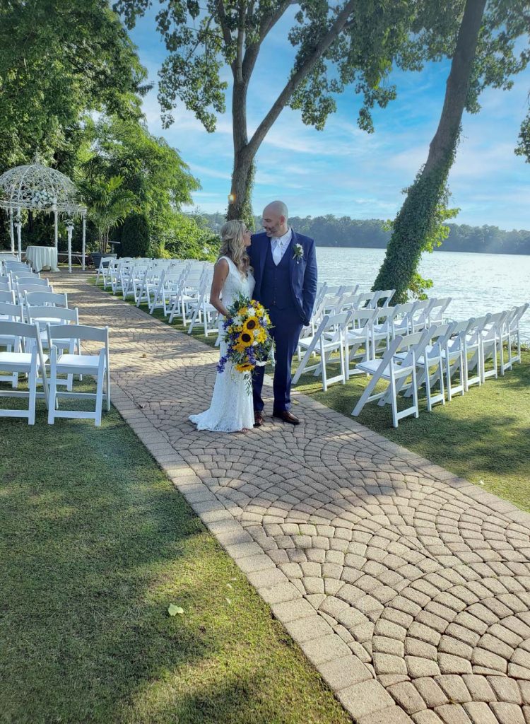 couple with sunflowers by water